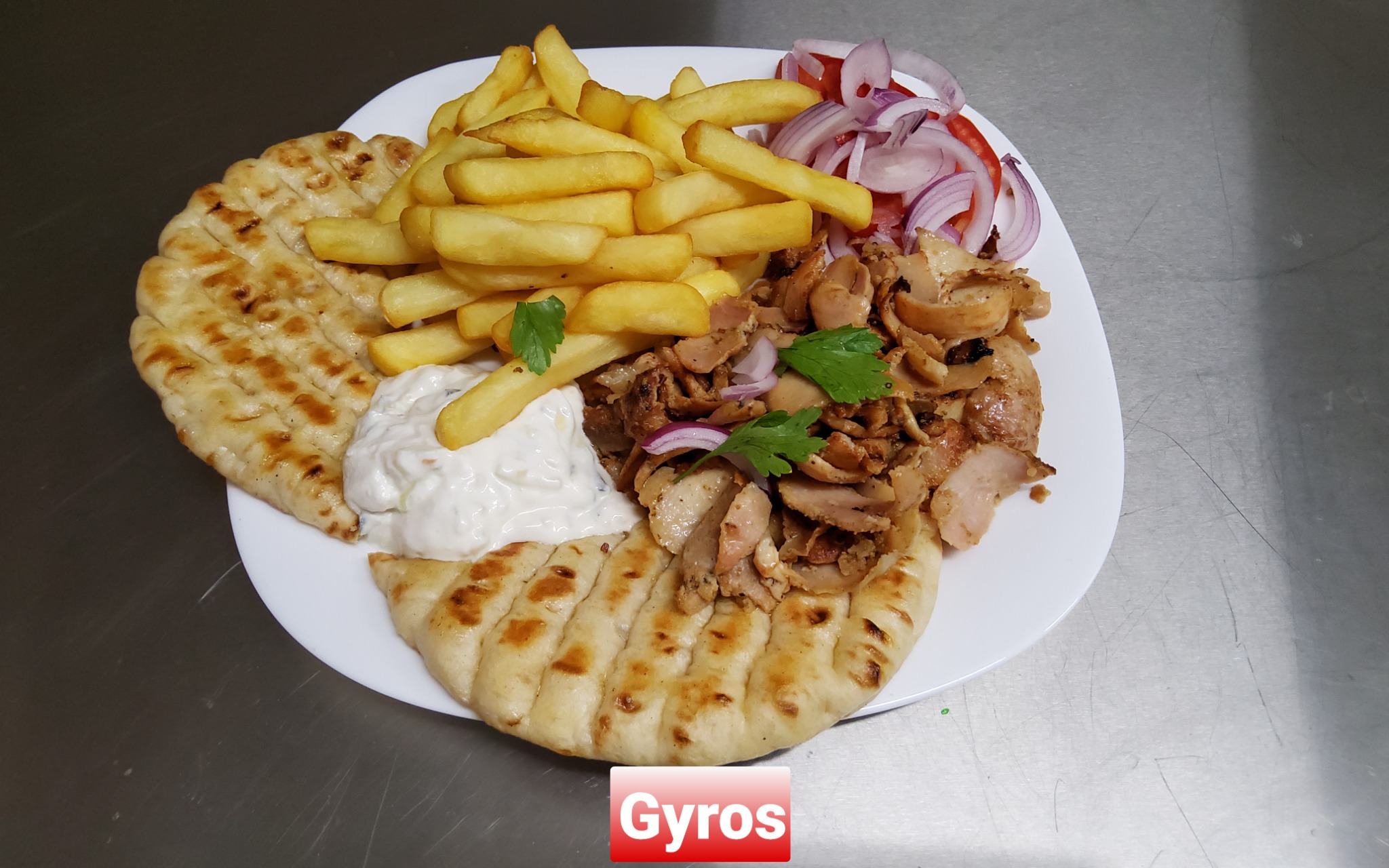Gyros plate with pita bread, fries and salad