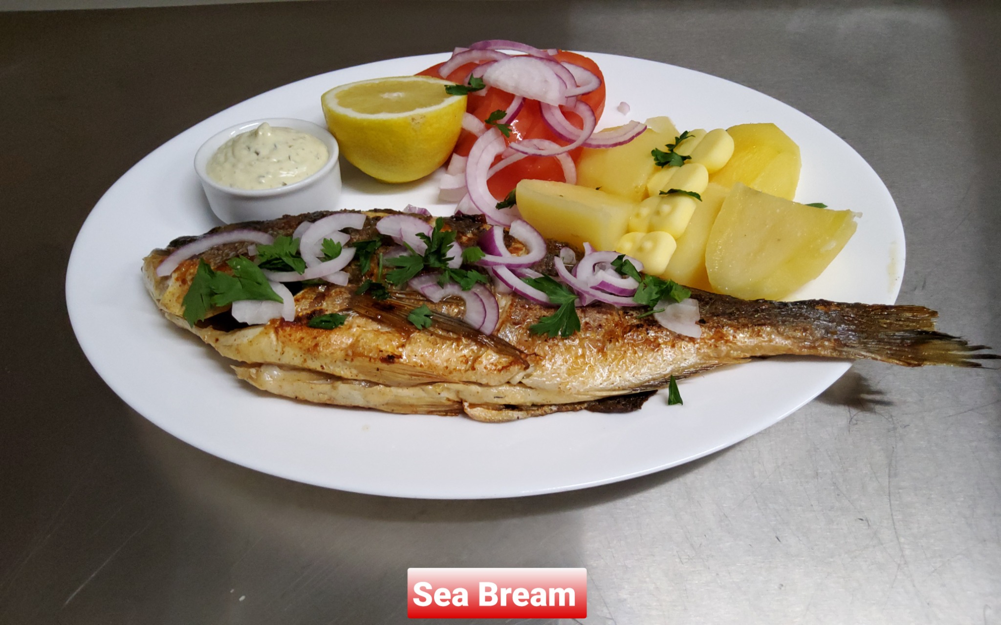 Grilled sea bream with potatoes and salad